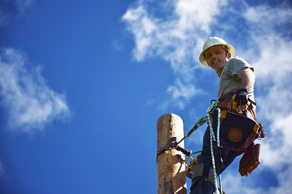 Powerline worker with blue sky background