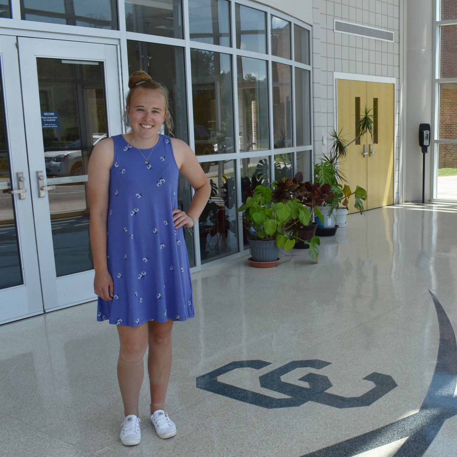 Laken Crockett Standing beside Carroll County High School Cavaliers Logo Tiled floor
