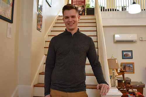 Steven Hutton standing on steps inside the Henderson building in Marion